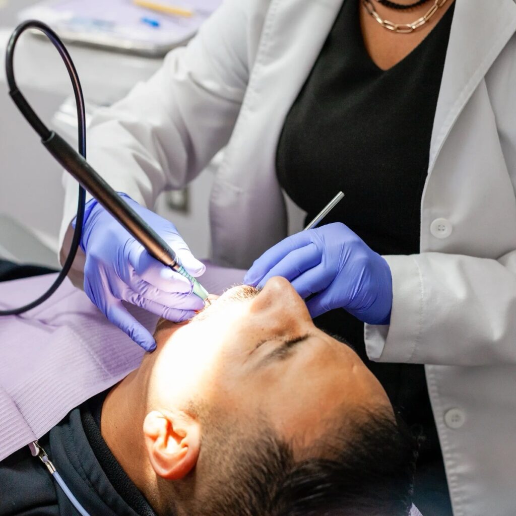 Patient checking in at the reception desk at A-Dental Center in North Hollywood, CA.